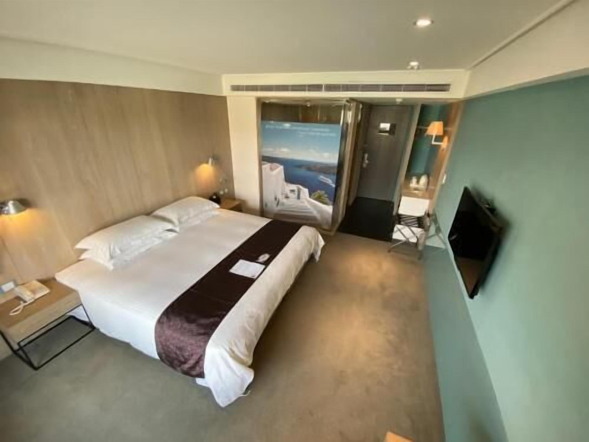 Premium bedding, desk, laptop workspace, blackout drapes