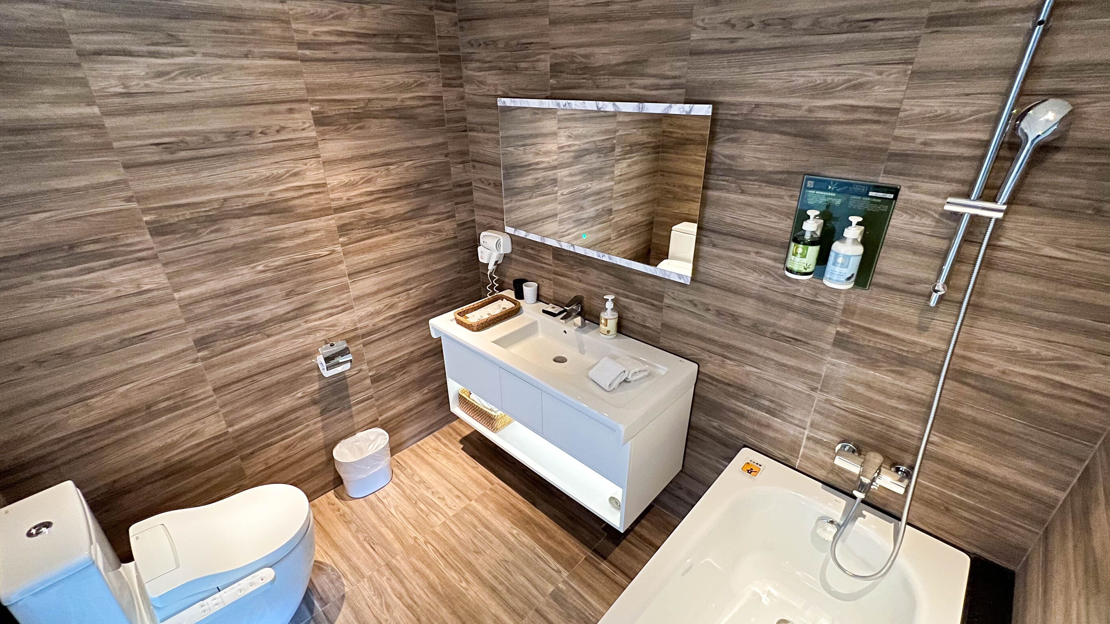 deluxe room, 1 king bed | bathroom | shower, hair dryer, slippers, towels