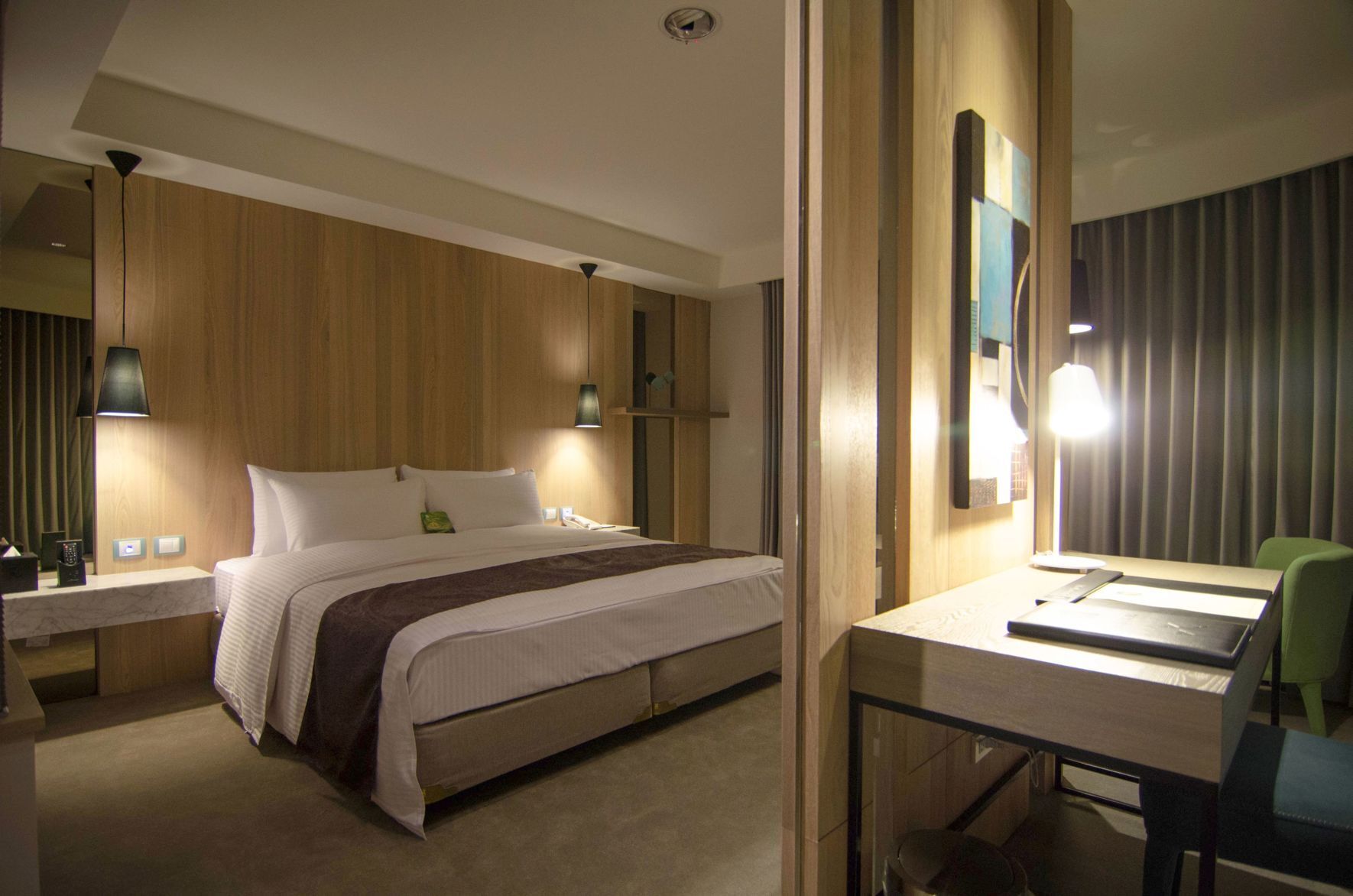 Premium bedding, desk, laptop workspace, blackout drapes