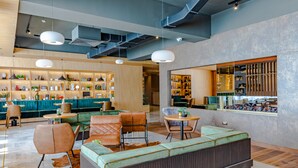 A modern lounge area with seating, a bar, and shelves with various items. - Hotel Sinaia (Sinaia)
