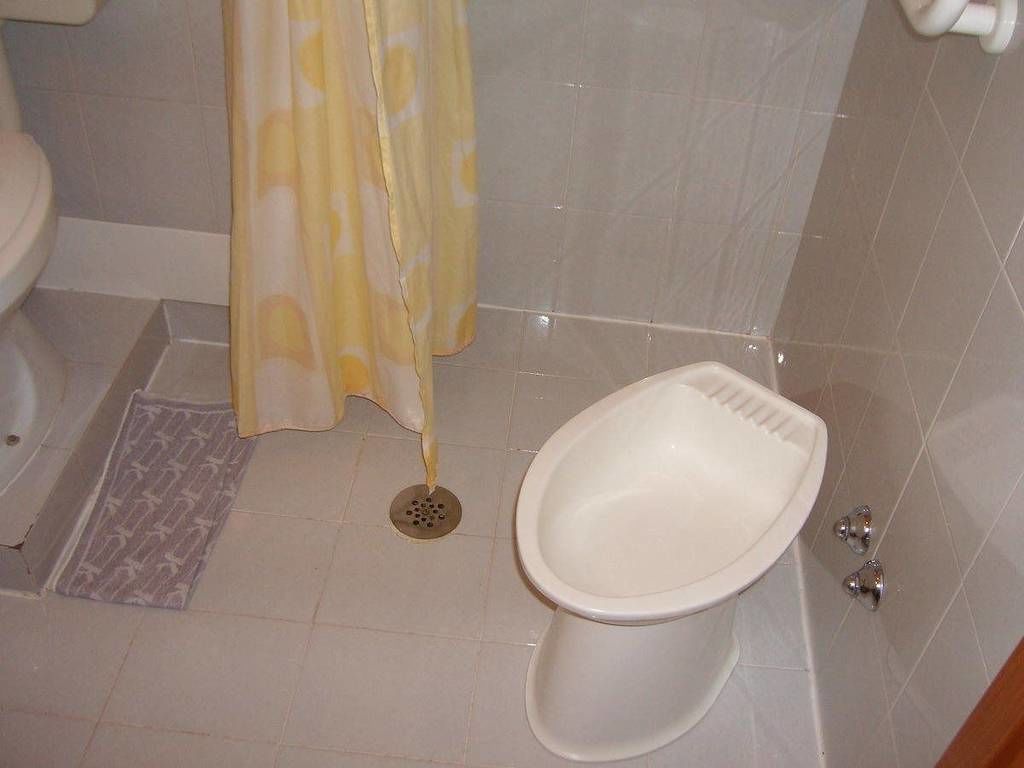 shower, hair dryer, slippers, towels