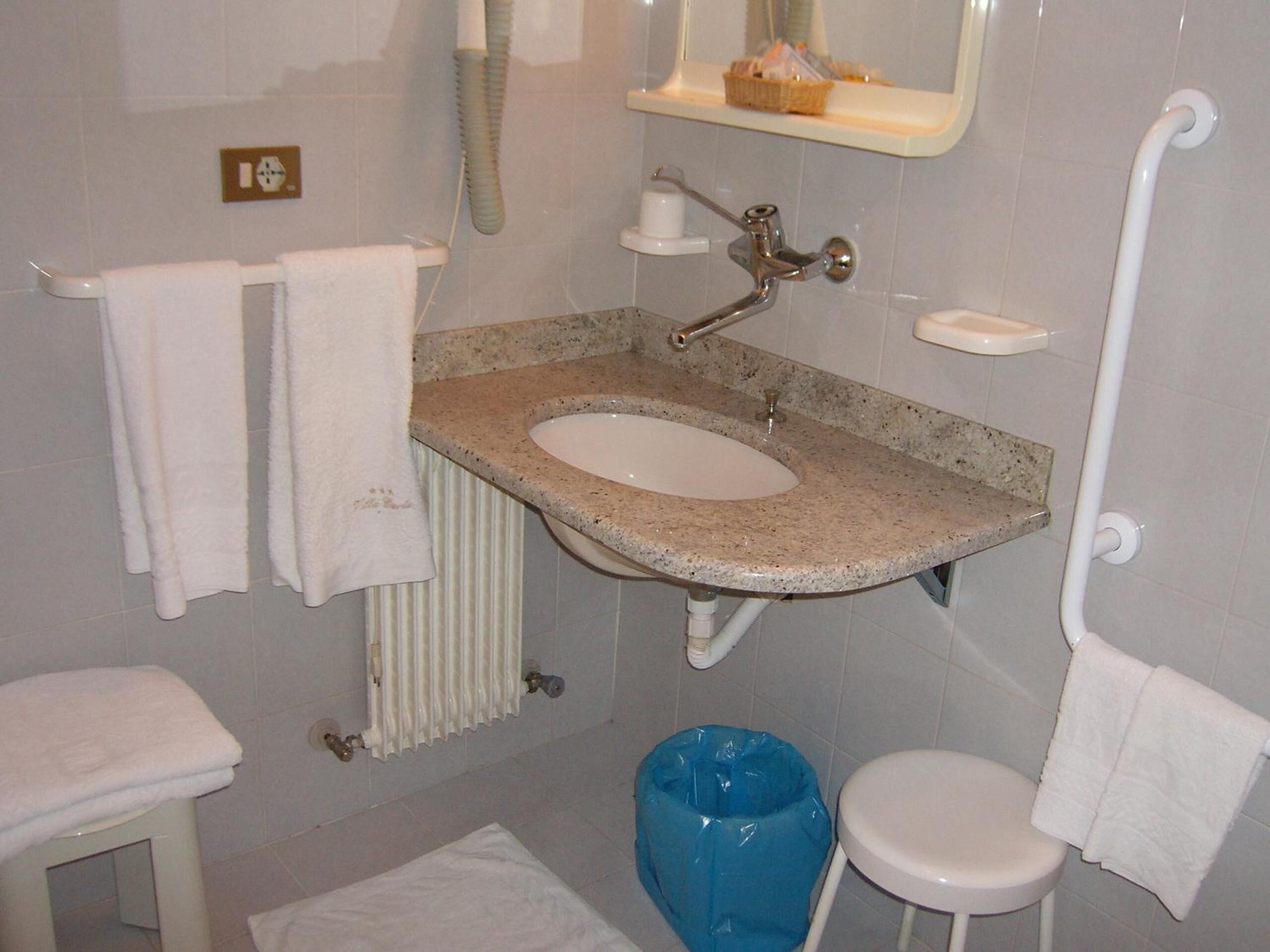 shower, hair dryer, slippers, towels