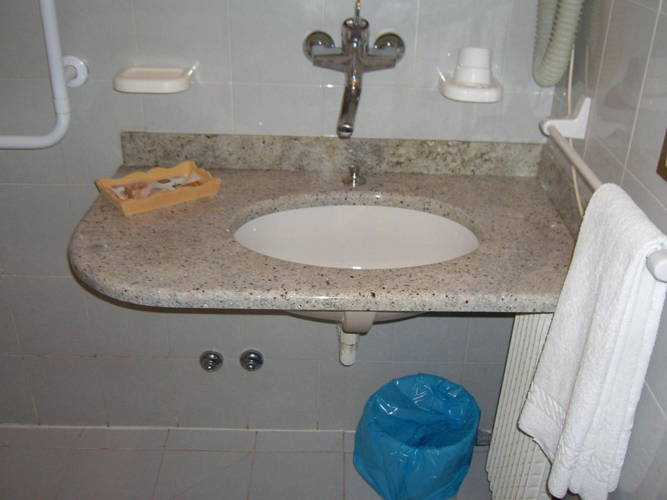 shower, hair dryer, slippers, towels