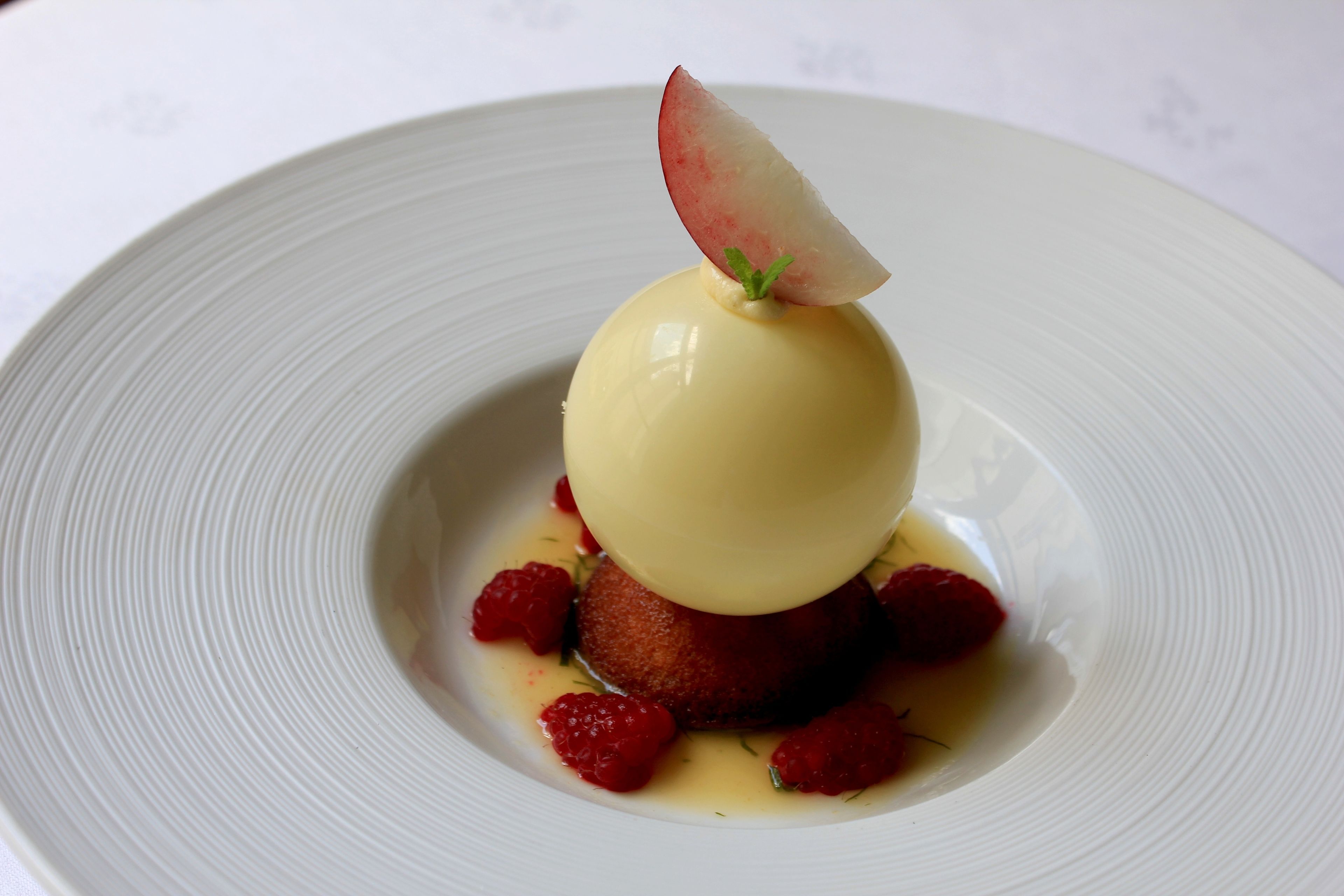 A dessert on a white plate with a smooth texture.