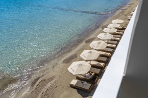 En la playa, sillas reclinables de playa, sombrillas