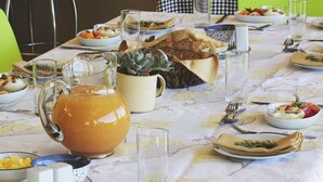 A dining table set with various dishes, glasses, and utensils, indicating a meal setting.