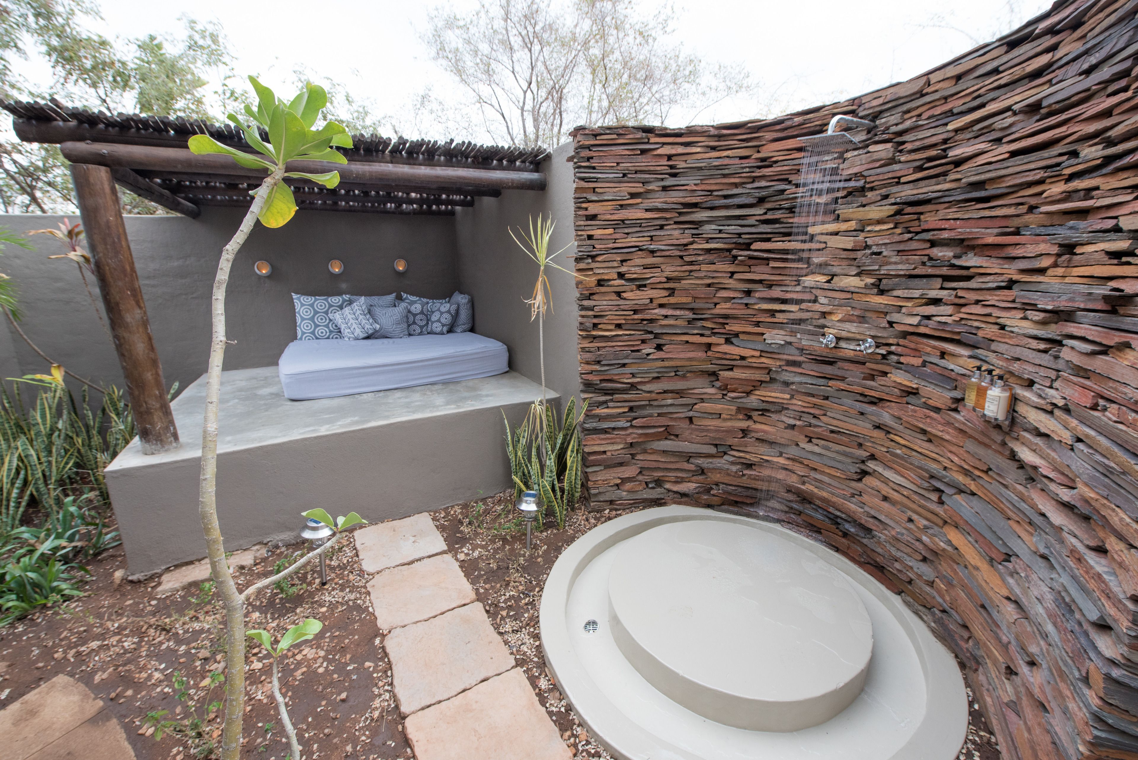 A circular stone wall with a built-in bench and a small circular seating area.
