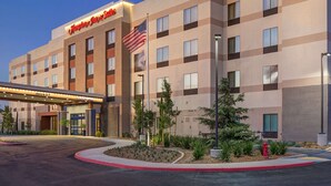 A hotel with a modern design, featuring a prominent American flag and a clear entrance. - Hampton Inn & Suites Murrieta Temecula (Murrieta)