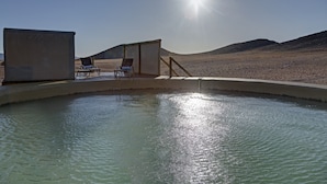 A pool area with lounge chairs and a sunshade structure. - Kanaan N/a'an ku sê Desert Retreat (Kanaan)