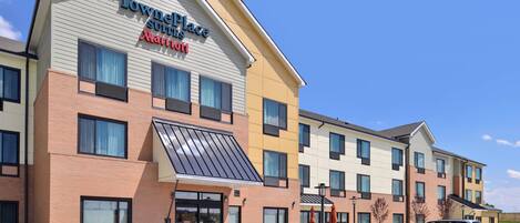 A TownePlace Suites hotel with a brick facade, large windows, and a parking lot.