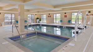 An indoor swimming pool with clear water, a lifeguard chair, and a no lifeguard required sign. - TownePlace Suites by Marriott Gillette (Gillette)