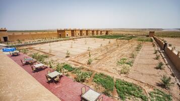 A courtyard with outdoor seating and a building in the background.