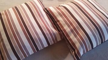 A striped pillow on a couch.