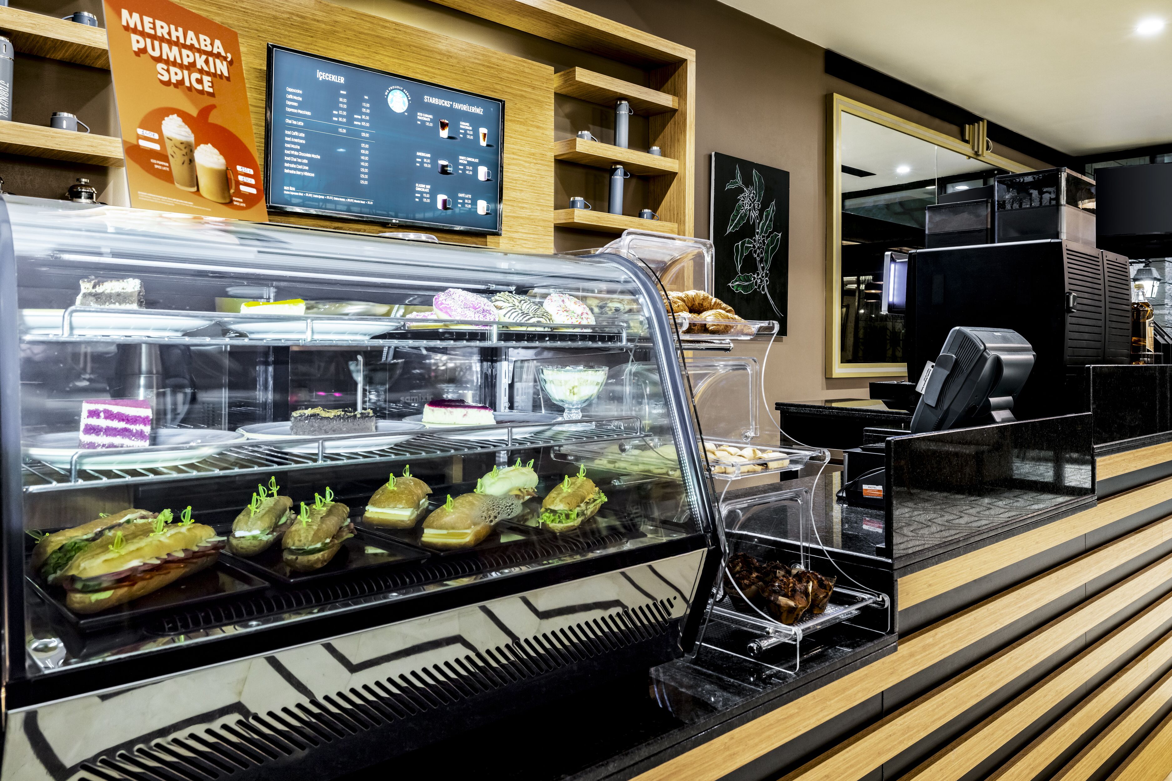 A bakery display case with various pastries and sandwiches.