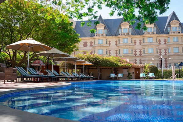 Alberca techada, alberca al aire libre y camastros