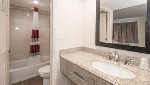 A bathroom with a shower, toilet, sink, and a large mirror. - Red Roof Inn Wildwood - Cape May/ Rio Grande (Rio Grande)