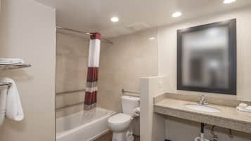A modern bathroom with a bathtub, toilet, and sink.