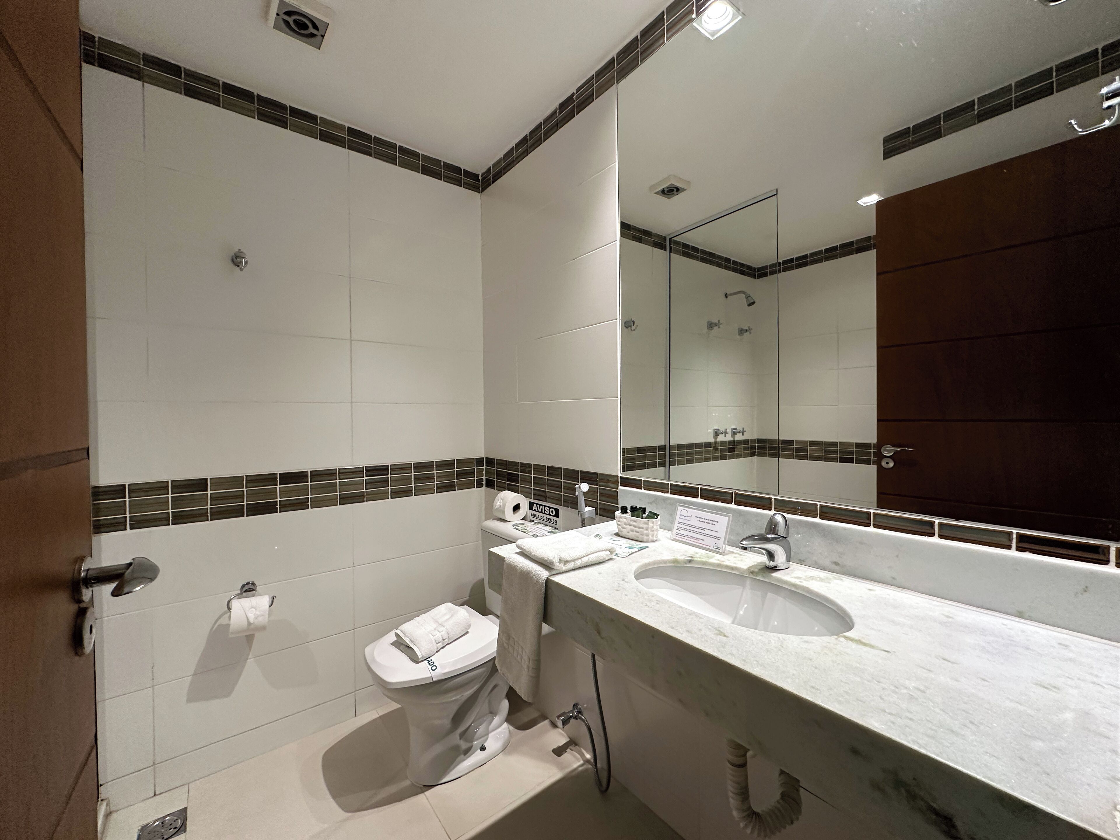 A bathroom with a toilet, bidet, and sink.