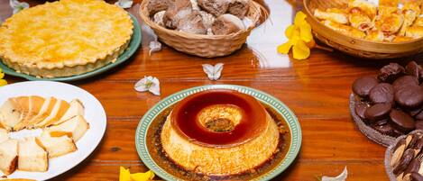 A buffet table with various food items including pies, cakes, and pastries.
