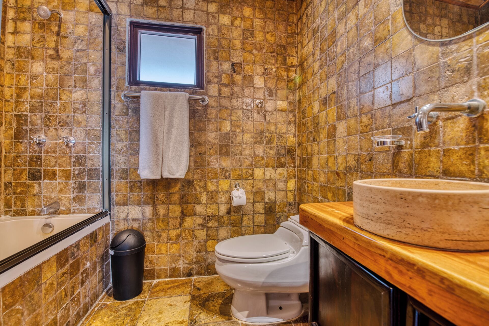 A bathroom with a bathtub, toilet, and sink.