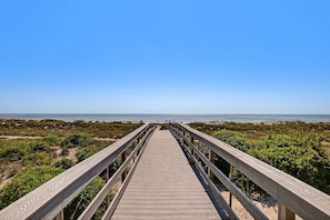 A wooden boardwalk leading to a beach with a clear sky. - Ocean Place Condo with Direct Access to the Beach by RedAwning (Fernandina Beach)