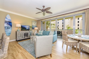 Relax in this inviting living space with a comfortable sofa, armchair, and dining area.