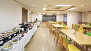 A buffet setup with multiple food stations and tables arranged in a spacious room. - Sun Hotel Hachioji (Hachioji)