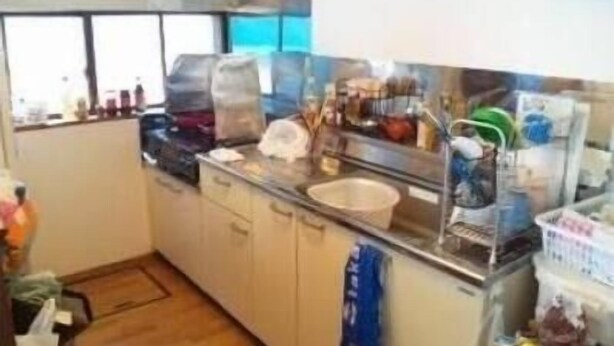A compact kitchen with a stove, sink, and various appliances.