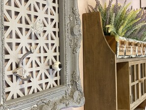 A decorative metal grille with a keyhole and a wooden planter with various herbs. - Anping Western-style House (Tainan)