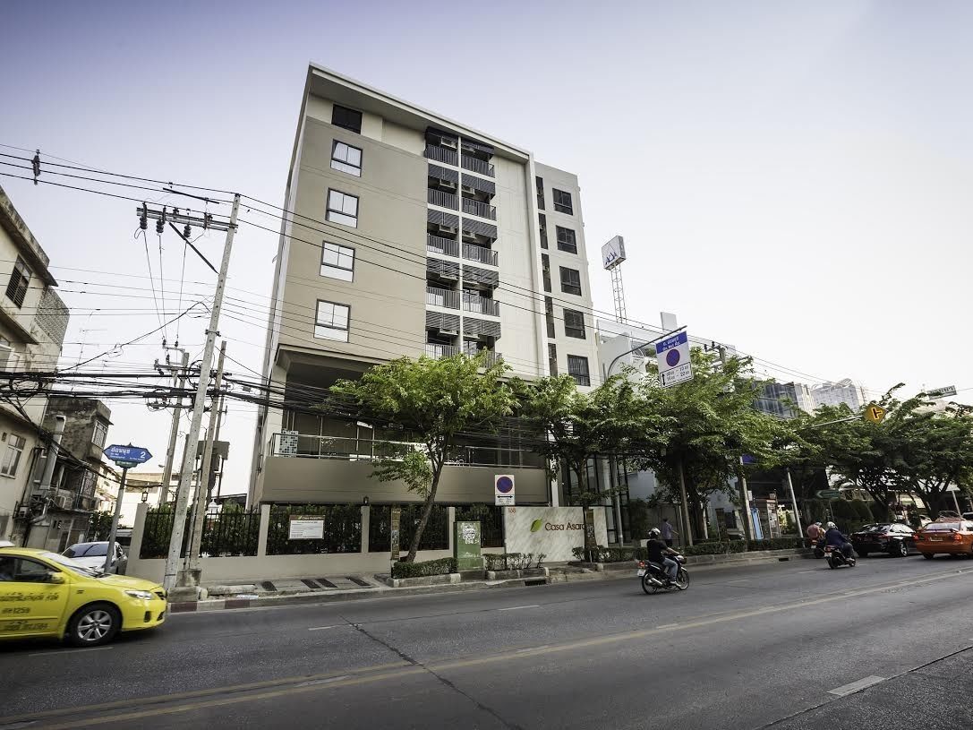 A multi-story building with a modern design, featuring balconies and a flat facade.