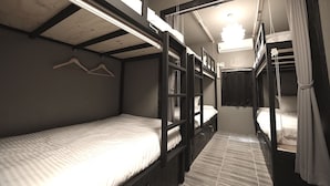 A bunk bed room with a wooden ceiling, a hanging light fixture, and a small window. - The Bay Guesthouse - Hostel (Busan)