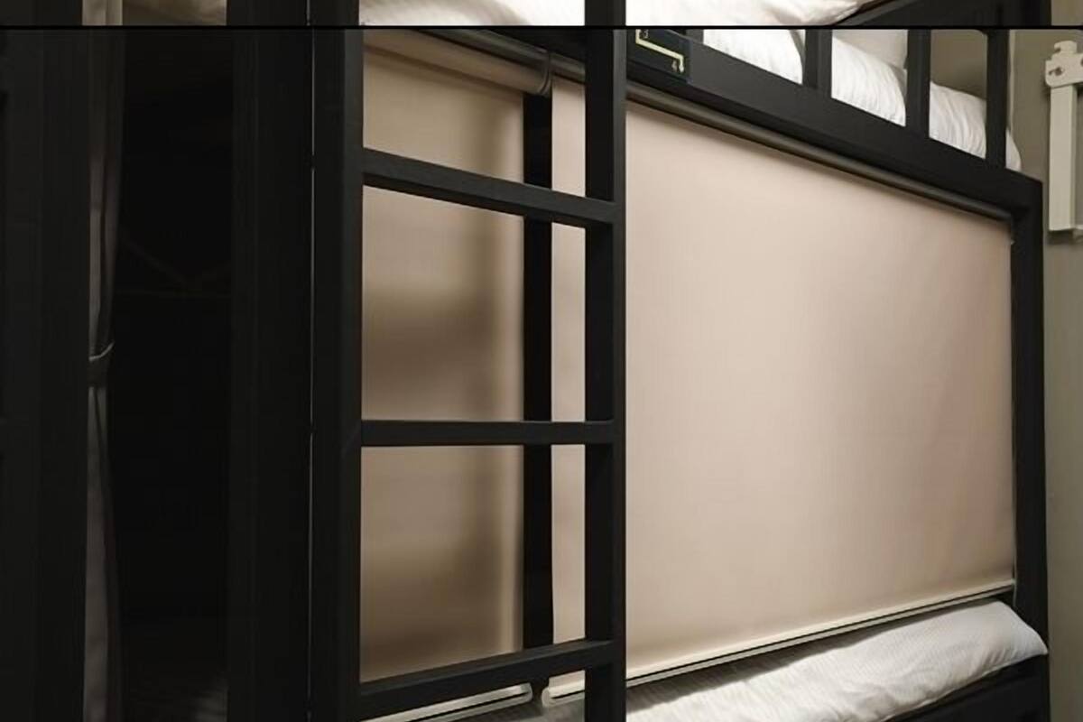 A bunk bed with a headboard and a pillow.