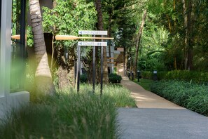 A pathway leading to a building with directional signs for 'The Port' and 'Toilet'. - Deevana Krabi Resort (Krabi)
