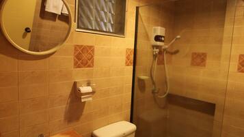 A bathroom with a sink, toilet, and shower.