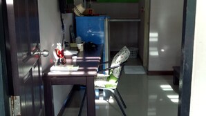A hallway with a dining area featuring a table, chairs, and a wall-mounted air conditioner.