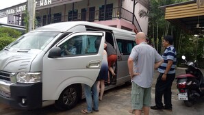 A white van parked in front of a building with a sign that reads "MAKE LOVE".