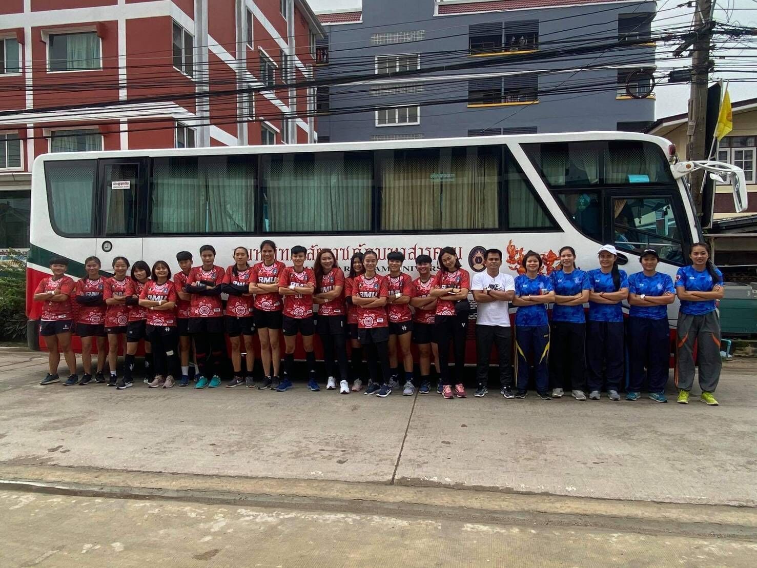 A group of people standing in front of a bus.