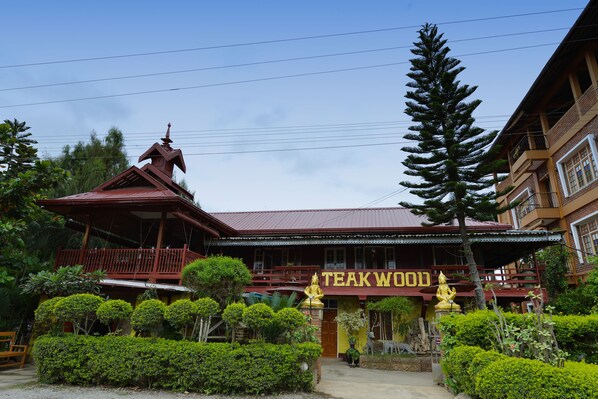 A traditional building with a sign reading "TEAK WOOD".