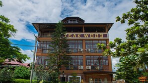 A two-story building with a sign reading "TEAK WOOD SPA SALON". - Teak Wood Hotel (Nyaungshwe)