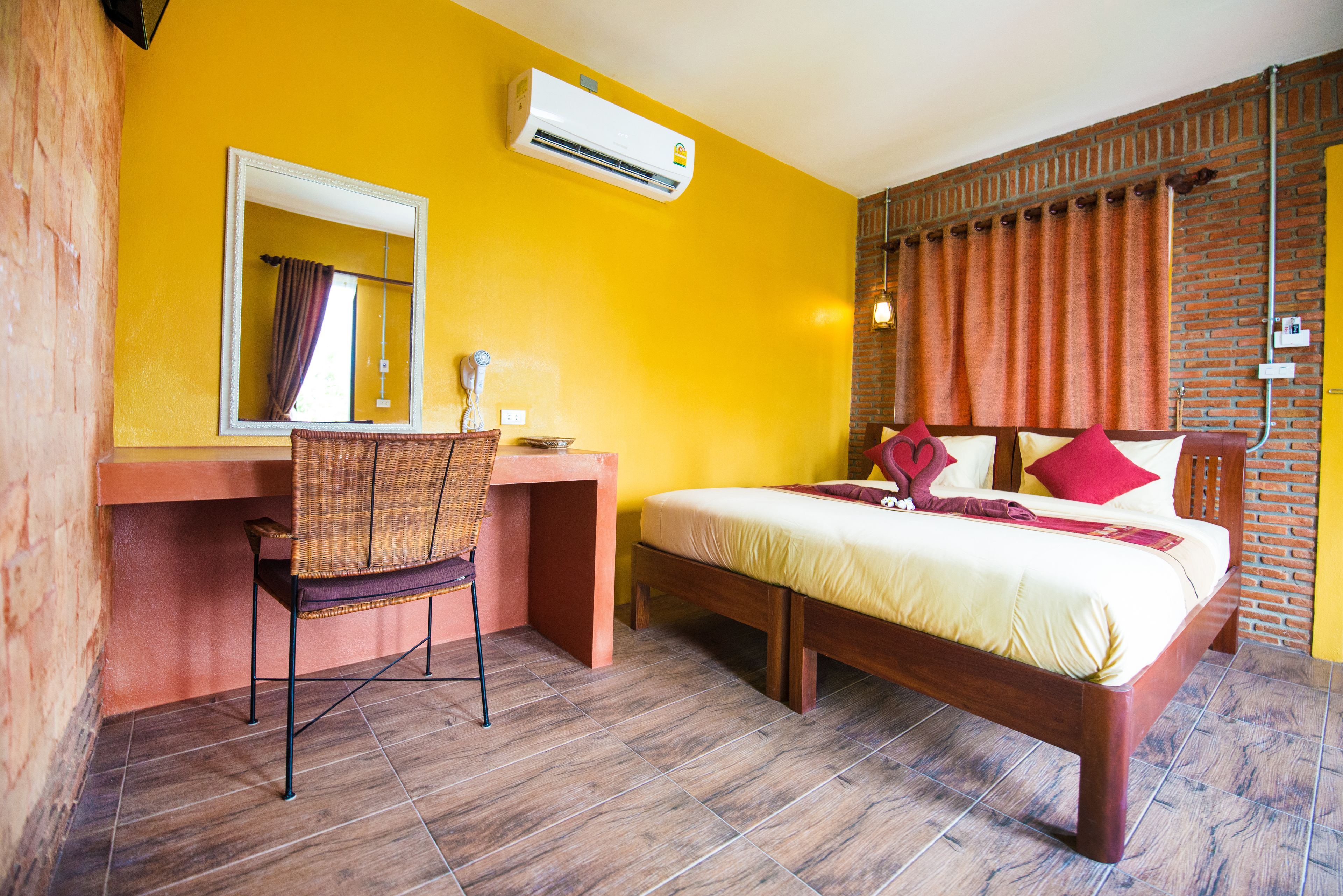 A room with a bed, a desk, and a chair.