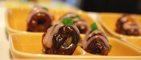 A close-up of a dish with food items in a yellow container.