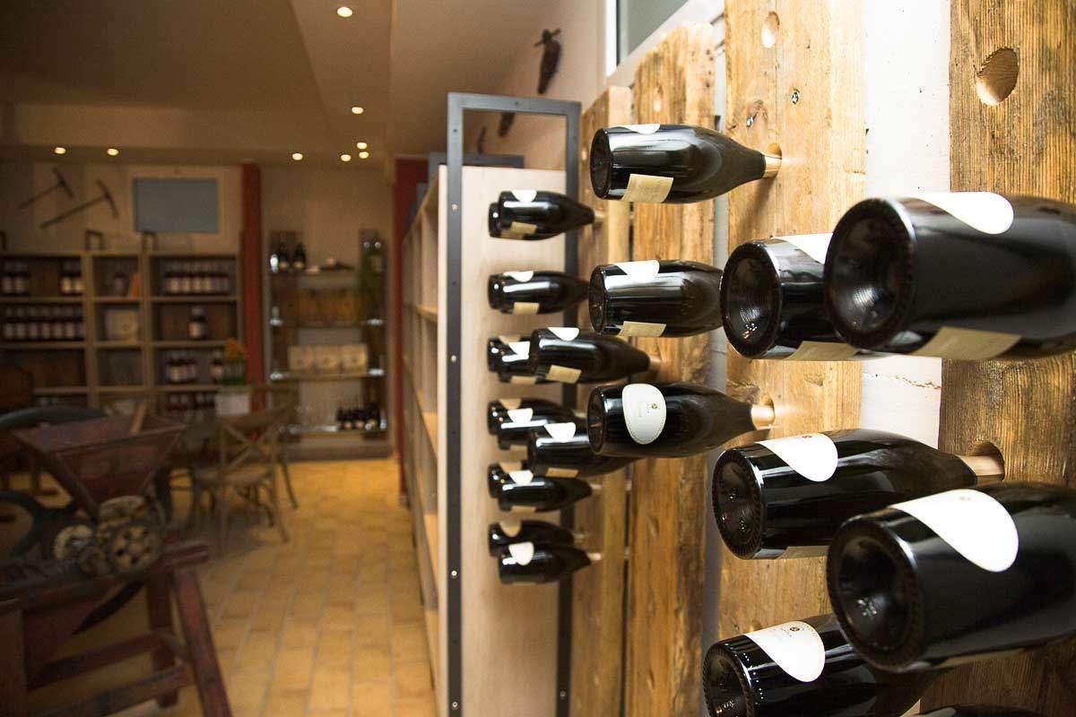 A wine cellar with bottles arranged on wooden racks.
