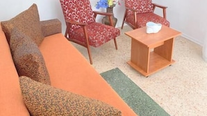A living room with a sofa, two patterned armchairs, a small wooden table, and a painting on the wall. - Tomis Hotel Neptun  (Neptun)