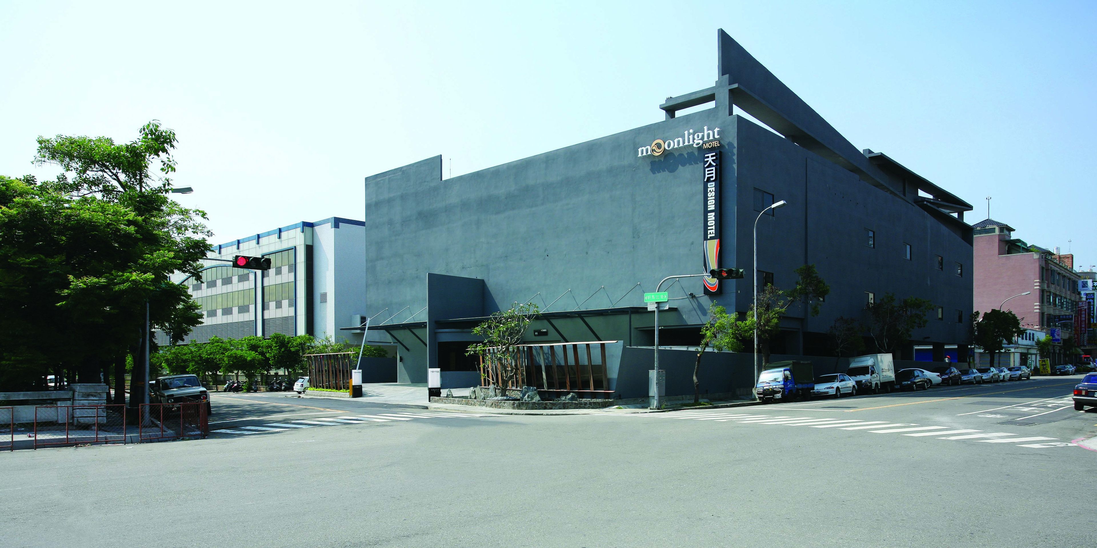 A modern building with a large sign for the Moonlight Hotel.