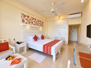 A hotel room with a bed, nightstands, a desk, a chair, and a television. - Beacon Beach Hotel (Negombo)