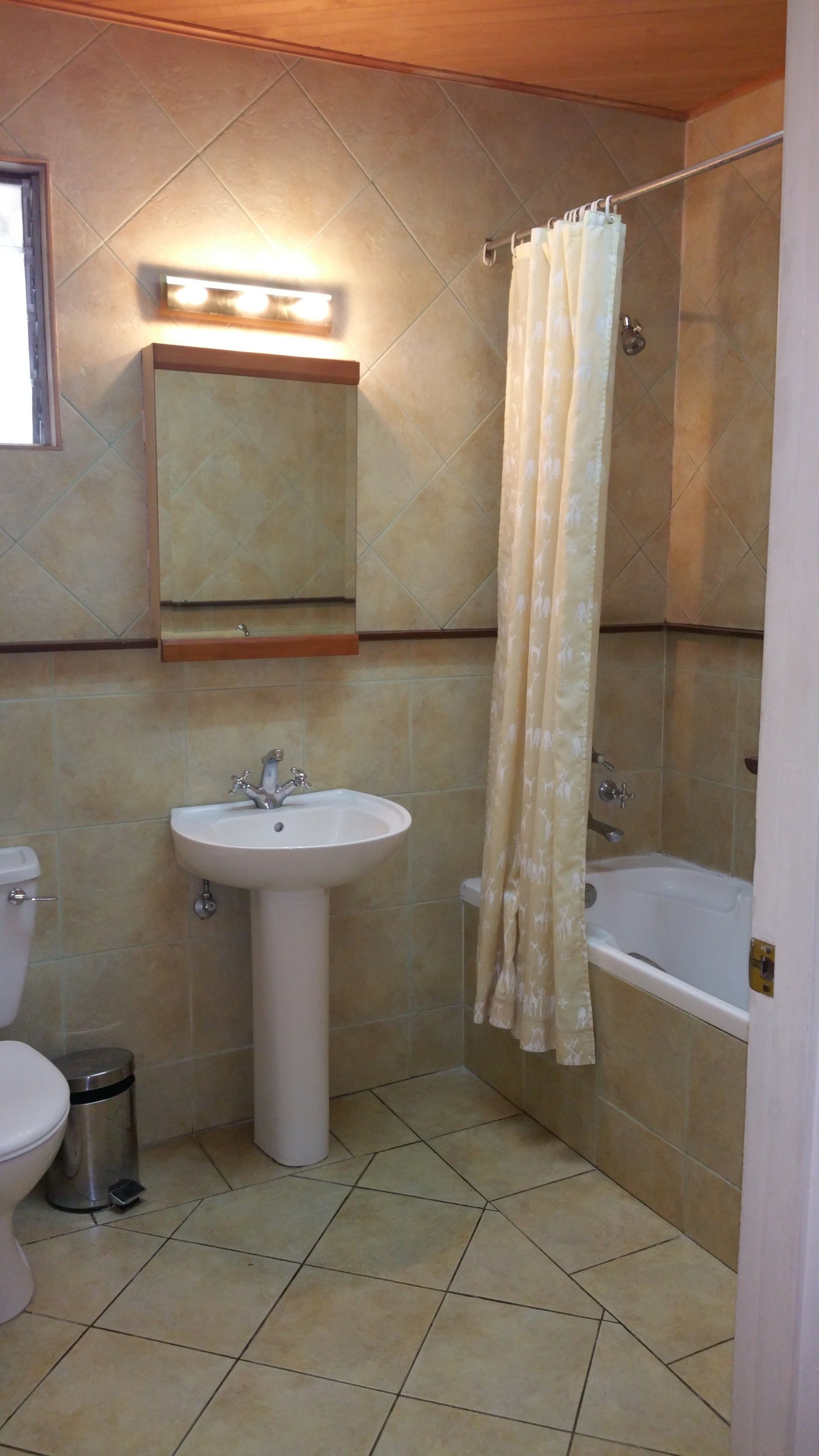 A bathroom with a sink, toilet, and bathtub.