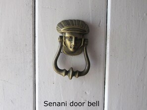 A Senani door bell with a decorative handle.