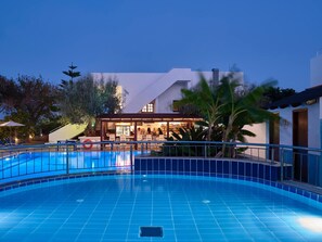 A swimming pool with a bar area and lounge chairs. - Lindos Athena Hotel (Rhodes)