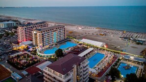 A resort with multiple swimming pools, a beach, and a large hotel building. - Phoenicia Luxury (Navodari)