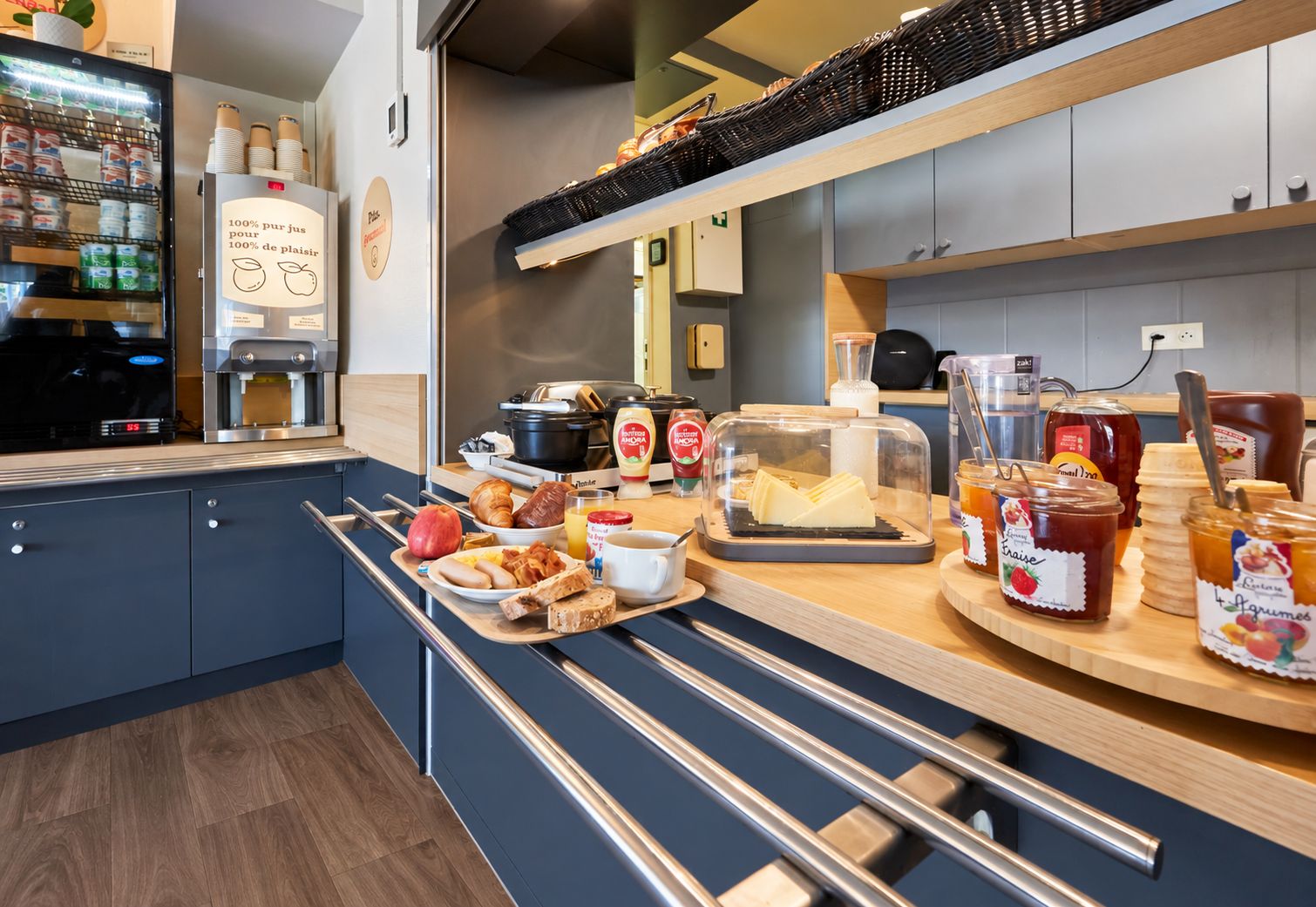 A breakfast buffet setup with a variety of food items and condiments.